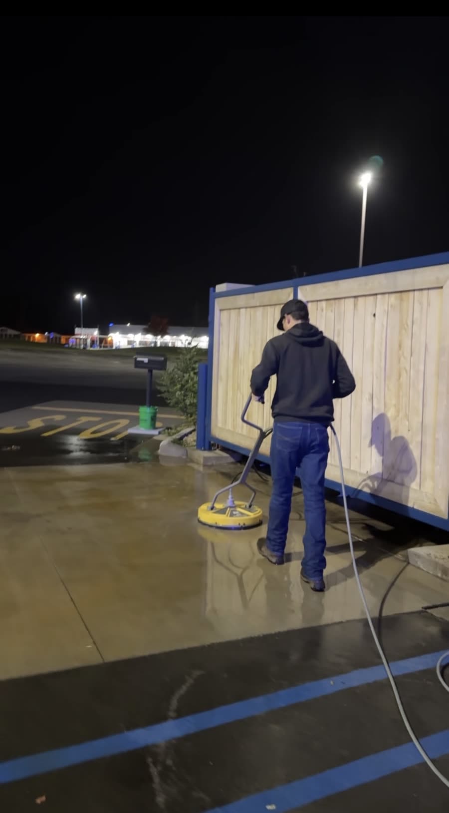 Washing a dumpster pad at night
