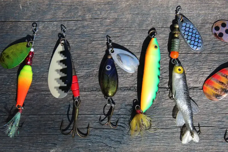 Spinners and spoons with treble hooks hanging in a row on a weathered board