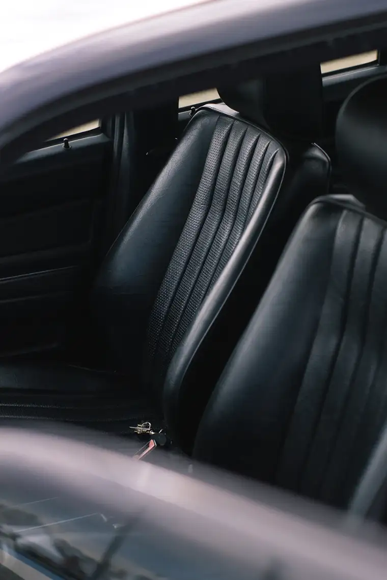 Black leather front seats with the car key on the driver seat
